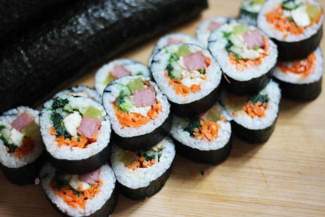 Sliced gimbap showing all the ingredients.