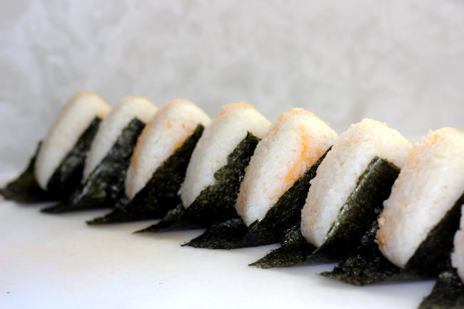 Eight crab onigiri displayed in a nice line. Like a line of ladies doing high kicks.