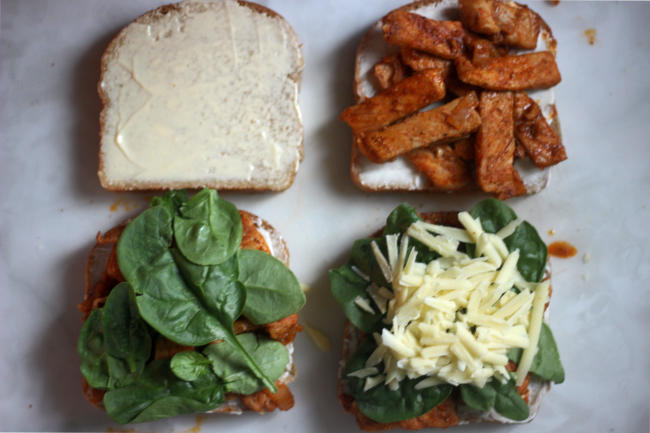 Photo shows how I layer my sandwich ingredient. Four slices of bread going from left to right, and starting with top two. First slice has mayo, second slice has mayo then pork. Bottom row. First slice has mayo, pork, then spinach. Second slice has mayo, pork, spinach, and then cheese. End description.